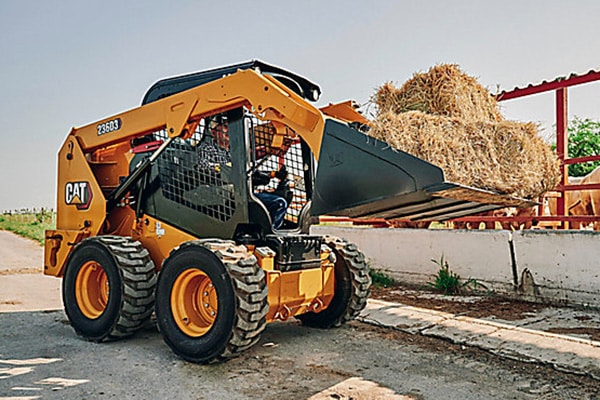 Yancey skid steer carrying hay